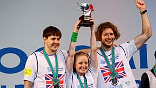 Members of team UK pose with their victory trophy at an award ceremony during a trash picking competition known as "Spogomi World Cup" in Tokyo.