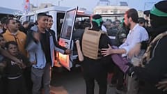 صورة مأخوذة من مقطع فيديو لمقاتلين من حماس يسلمون رهائن إلى الصليب الأحمر 