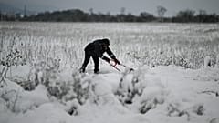 A local resident clears snow from a path after heavy snowfall, on the outskirts of Sofia, Bulgaria on Sunday