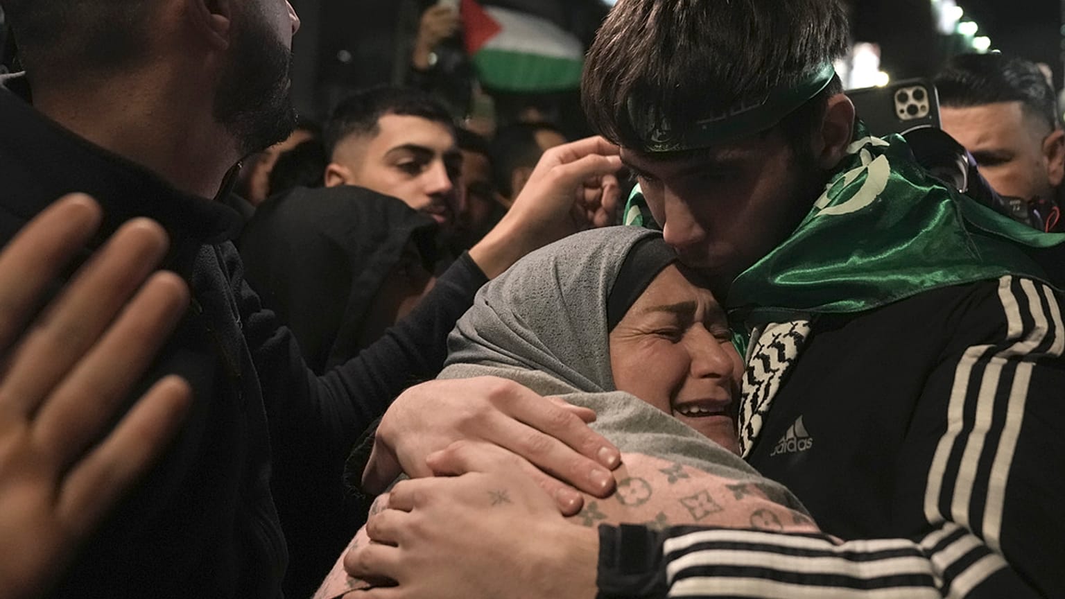 Omar Atshan, 17 anos, é abraçado pela sua mãe depois de ter sido libertado de uma prisão israelita na cidade de Ramallah, na Cisjordânia, no domingo