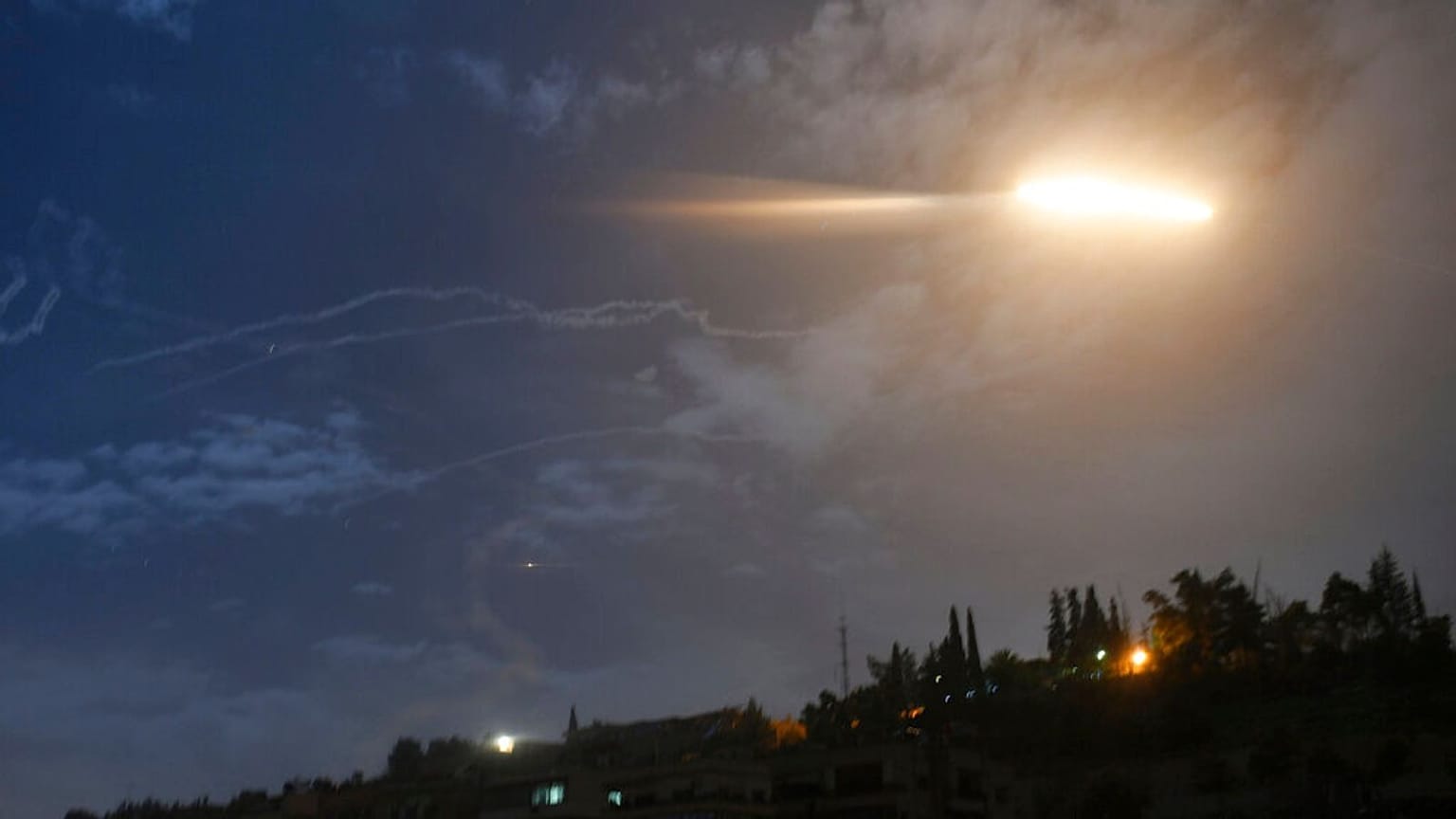 missiles flying into the sky near international airport, in Damascus