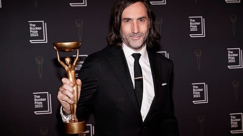 Irish writer Paul Lynch holds aloft the Booker Prize trophy for fiction at the London award ceremony, His fifth novel 'Prophet Song' was the judges top choice.  