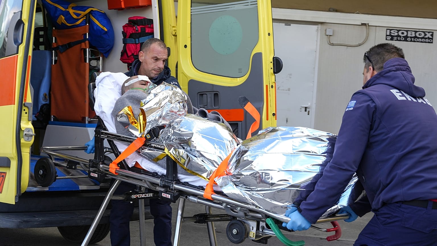 Paramedics transfer a survivor of a shipwreck at a hospital, on the northeastern Aegean Sea island of Lesbos, Greece, Sunday, Nov. 26, 2023.
