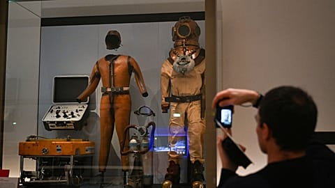 This picture taken on November 16, 2023 shows old material of underwater immersion displayed at the French National Navy museum in Paris. 