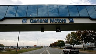 A trucks passes below a walkway at the General Motors Oshawa, Canada assembly plant
