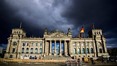 Rain clouds gather over the Reichstag building which houses Germany's lower house of parliament (Bundestag) in Berlin on September 28, 2022.