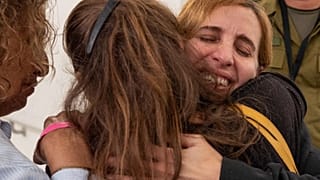 Former captive Danielle Aloni embraces family members upon her arrival at a hospital in Israel, following her release by Hamas in Gaza on 24 November 24