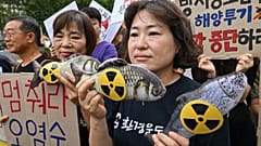 South Korean environmental activists hold fish dolls with radioactive signs during a rally against the Japanese government's plan to release wastewater from the stricken Fukus