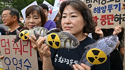 South Korean environmental activists hold fish dolls with radioactive signs during a rally against the Japanese government's plan to release wastewater from the stricken Fukus