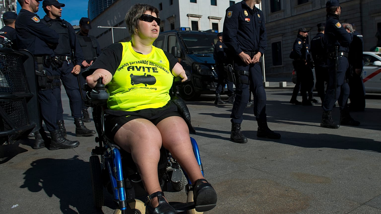 A disabled woman affected by phocomelia (malformation of the limbs) due to thalidomide medicine drives a wheelchair during a protest in front of the Spanish parliament in 2015