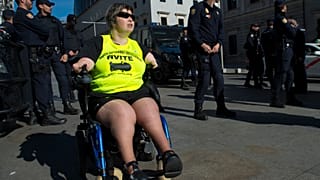 A disabled woman affected by phocomelia (malformation of the limbs) due to thalidomide medicine drives a wheelchair during a protest in front of the Spanish parliament in 2015