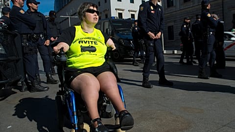 A disabled woman affected by phocomelia (malformation of the limbs) due to thalidomide medicine drives a wheelchair during a protest in front of the Spanish parliament in 2015