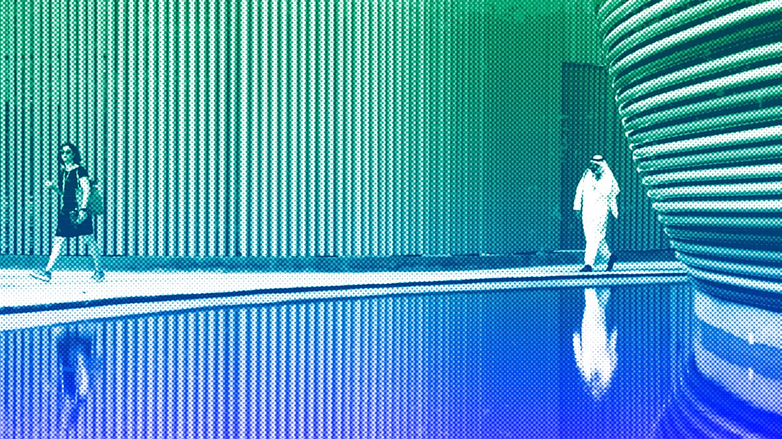 People walk through the venue for the COP28 UN Climate Summit in Dubai, November 2023