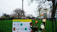 Flowers are lain near where a tourist was stabbed to death near the Eiffel Tower in Paris