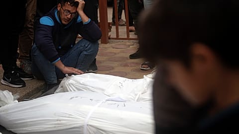 Palestinians mourn their relatives killed, in the Israeli bombardment, at the Nasser hospital in town of Khan Younis, southern Gaza Strip, Wednesday, Nov. 22, 2023.