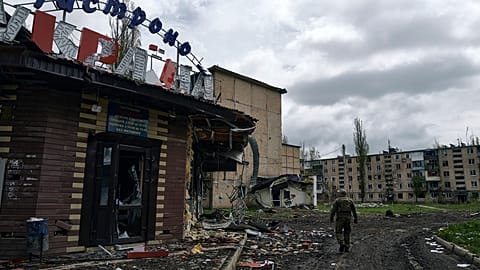 A Ukrainian soldier walks in Avdiivka, the site of heavy battles with the Russians in the Donetsk region, Ukraine, Friday, April 28, 2023.