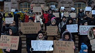 Un grupo de personas sostiene carteles en los que se lee "Devuelvan a los defensores de Mariupol", "Liberen Azov", durante una manifestación en el centro de Kiev, Ucrania.