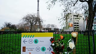 Esta fotografía tomada el 3 de diciembre de 2023 muestra flores donde un turista fue asesinado a cuchilladas, cerca de la Torre Eiffel (al fondo), en París.