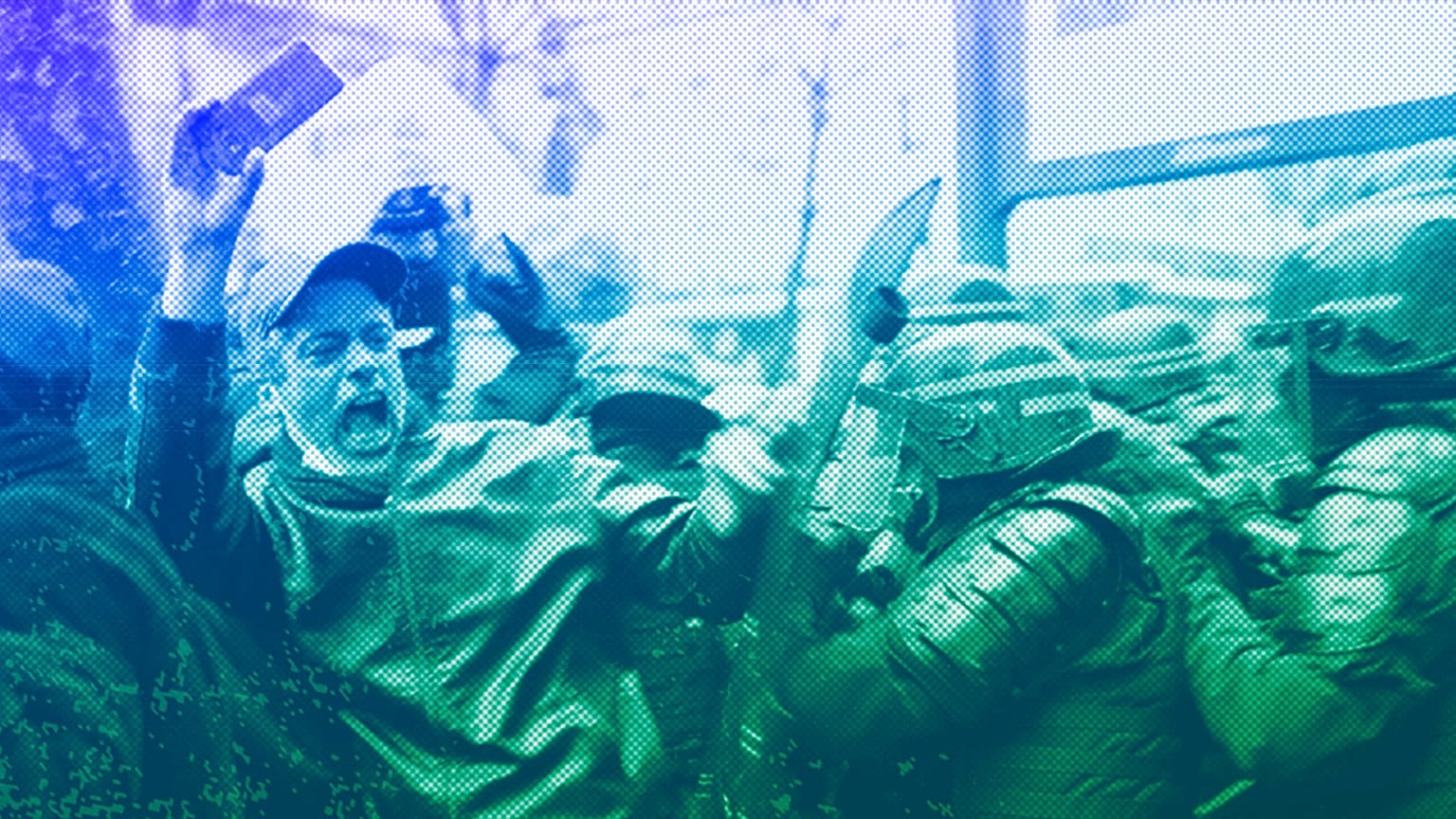 Riot police officers charge a man holding his phone during a protest rally in Paris, December 2020