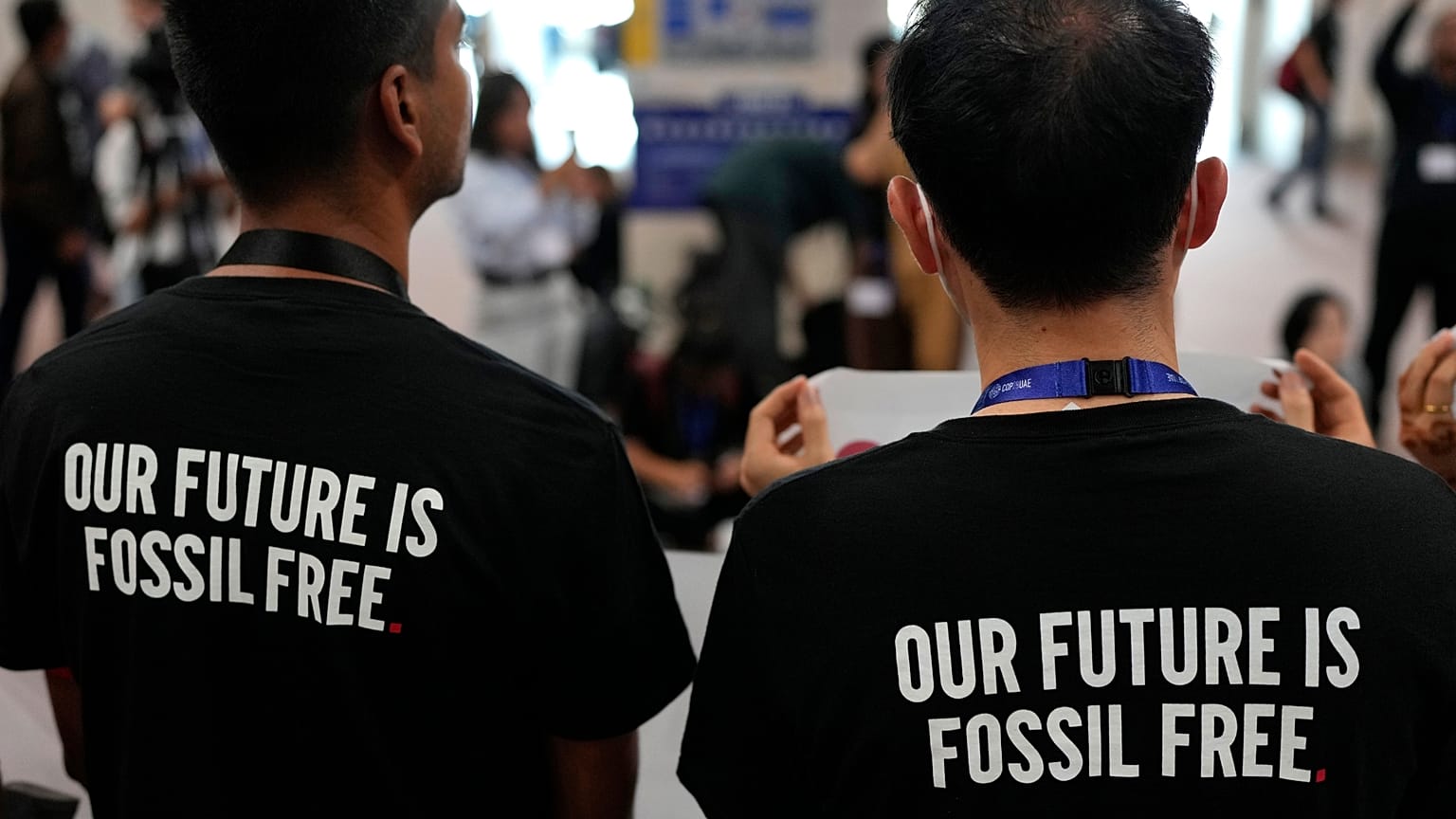 Activists wear shirts that read "our future is fossil free" at COP28.
