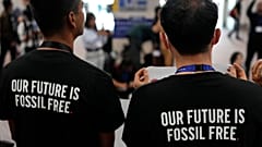 Activists wear shirts that read "our future is fossil free" at COP28.