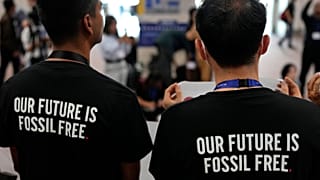 Activists wear shirts that read "our future is fossil free" at COP28.