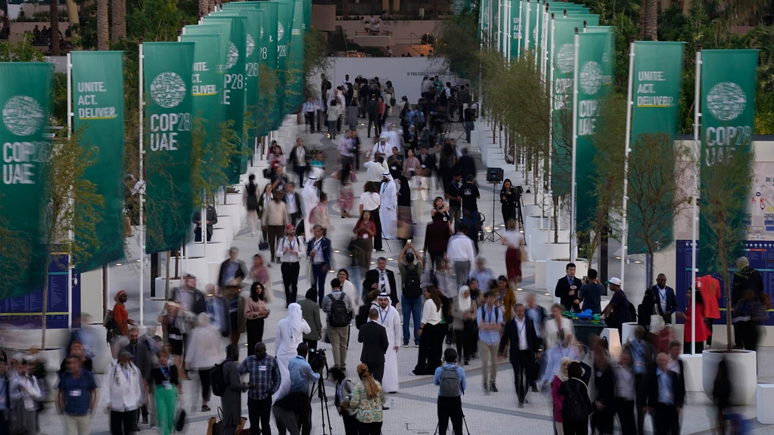 People walk through the COP28 UN Climate Summit.