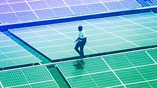 Mark Munyua, CP solar's technician, examines solar panels on the roof of a company in Nairobi, September 2023