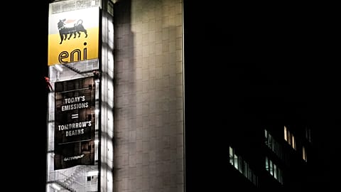 Greenpeace environmental organization activist unroll a banner on the ENI, Italian oil and gas company, headquarters building, in Rome
