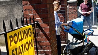 A woman leaves a polling station after casting her vote in the referendum on the 8th Amendment of the Irish Constitution, in Dublin, Ireland, Friday May 25, 2018.