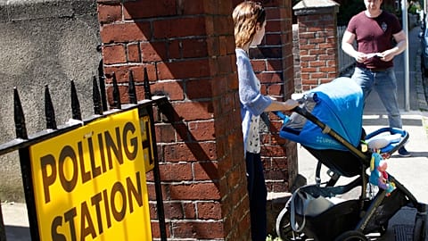 A woman leaves a polling station after casting her vote in the referendum on the 8th Amendment of the Irish Constitution, in Dublin, Ireland, Friday May 25, 2018.