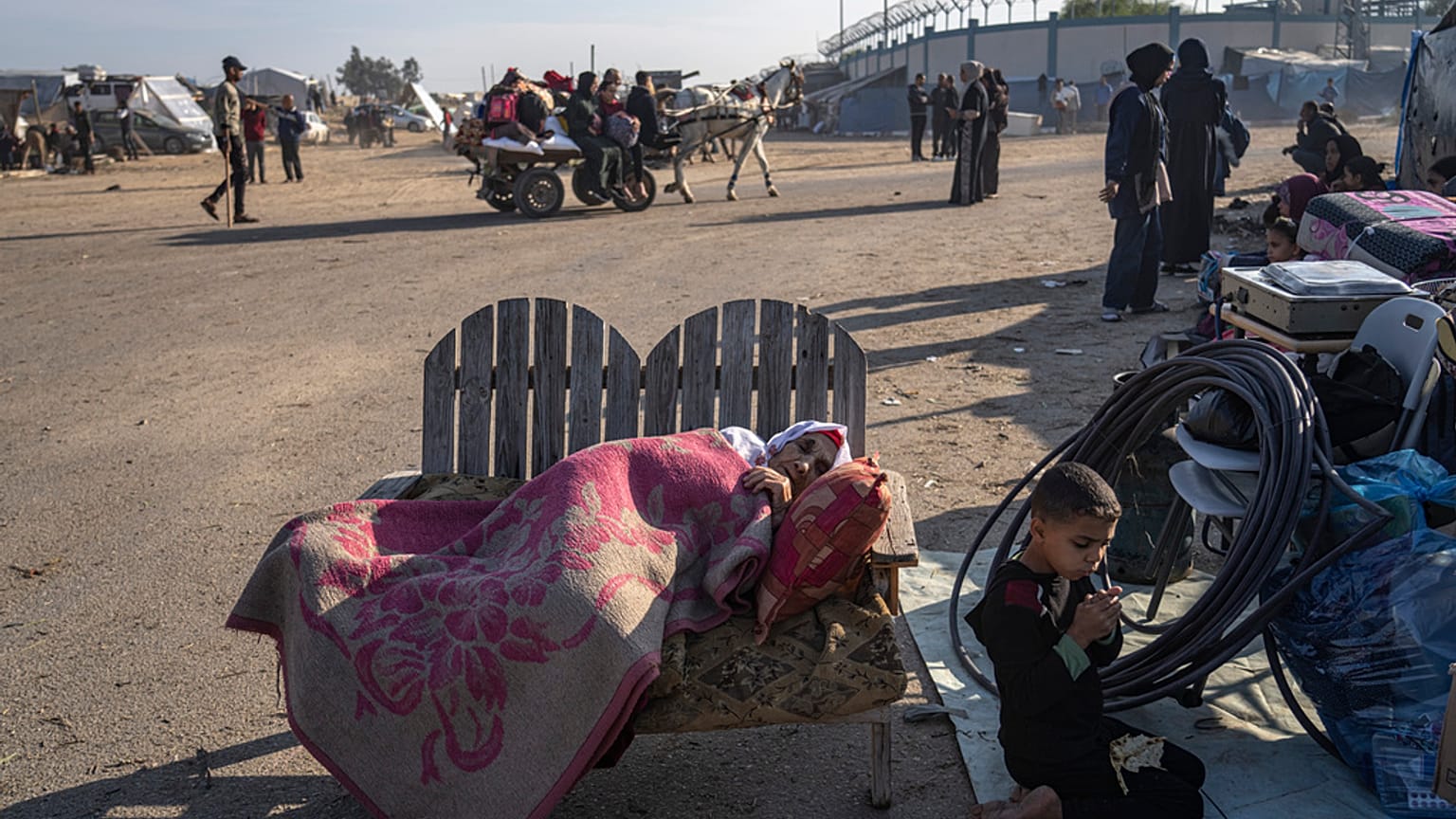 Palestinians displaced by the Israeli bombardment of the Gaza Strip gather at a tent camp, in Rafah, southern Gaza strip