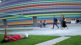 A woman talks on the phone at the COP28 UN climate summit, Wednesday, 6 December in Dubai, United Arab Emirates.