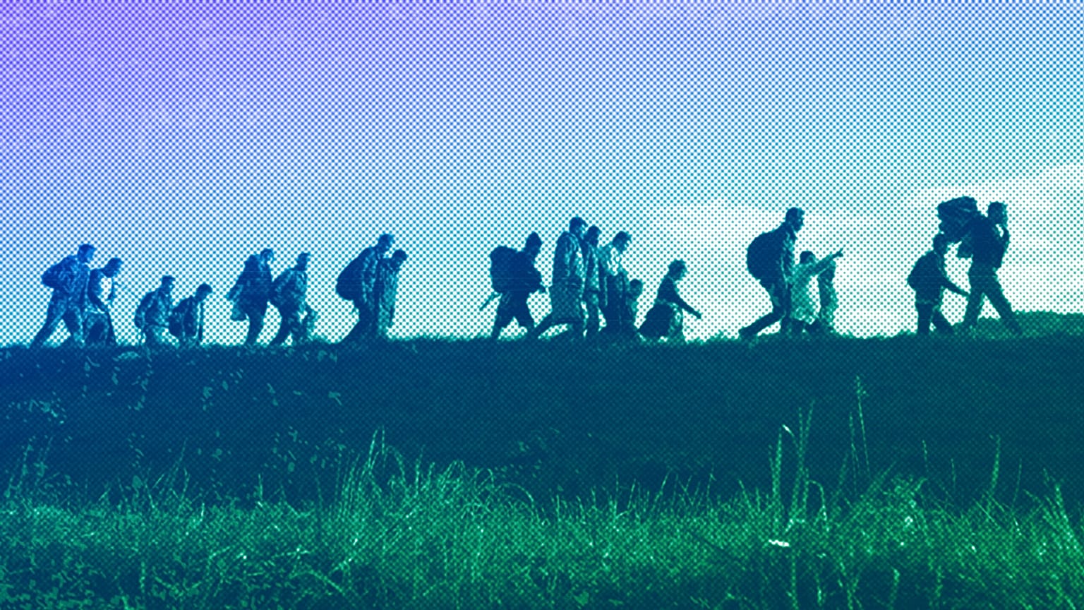 Migrants walk on a dyke after crossing from Croatia, in Brezice, Slovenia, October 2015