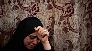 FILE- A Palestinian woman weeps during a funeral.