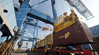 Ship-to-shore gantry cranes unload a cargo, on February 27, 2012, at the Montoir-de-Bretagne terminal, western France.