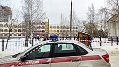 Law enforcement officers stand guard outside Gymnasium Number Five following a shooting, in Bryansk on Thursday