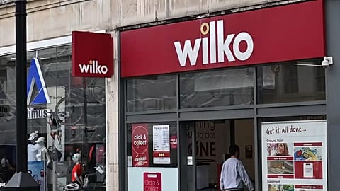 A cyclist rides past a branch of "Wilko" in west London on August 3, 2023. Wilko, August 3, has said it intends to appoint administrators, potentially putting up to 12,000 job