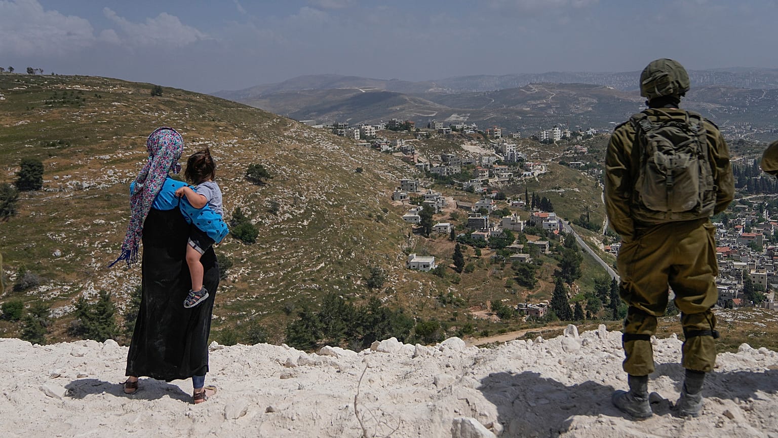 Israeli soldiers secure the construction site as Jewish settlers work at a seminary that was built overnight in the West Bank outpost of Homesh, Monday, May 29, 2023