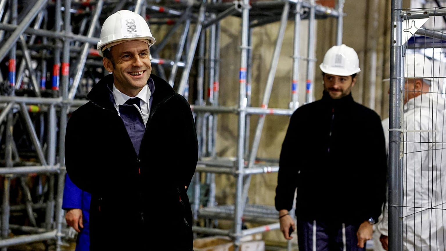 French President Emmanuel Macron (L) walks inside the nave during a visit of the reconstruction work at the Notre-Dame de Paris Cathedral.