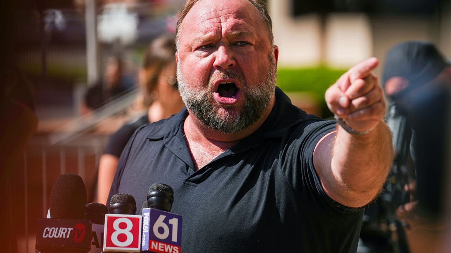 InfoWars founder Alex Jones speaks to the media outside Waterbury Superior Court during his trial in Waterbury, Connecticut last year