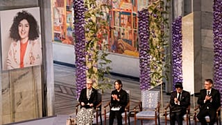 Ali, second right, and Kiana Rahmani, second left, attend the awarding of the Nobel Peace Prize for 2023 to their mother, imprisoned Iranian activist Narges Mohammadi.
