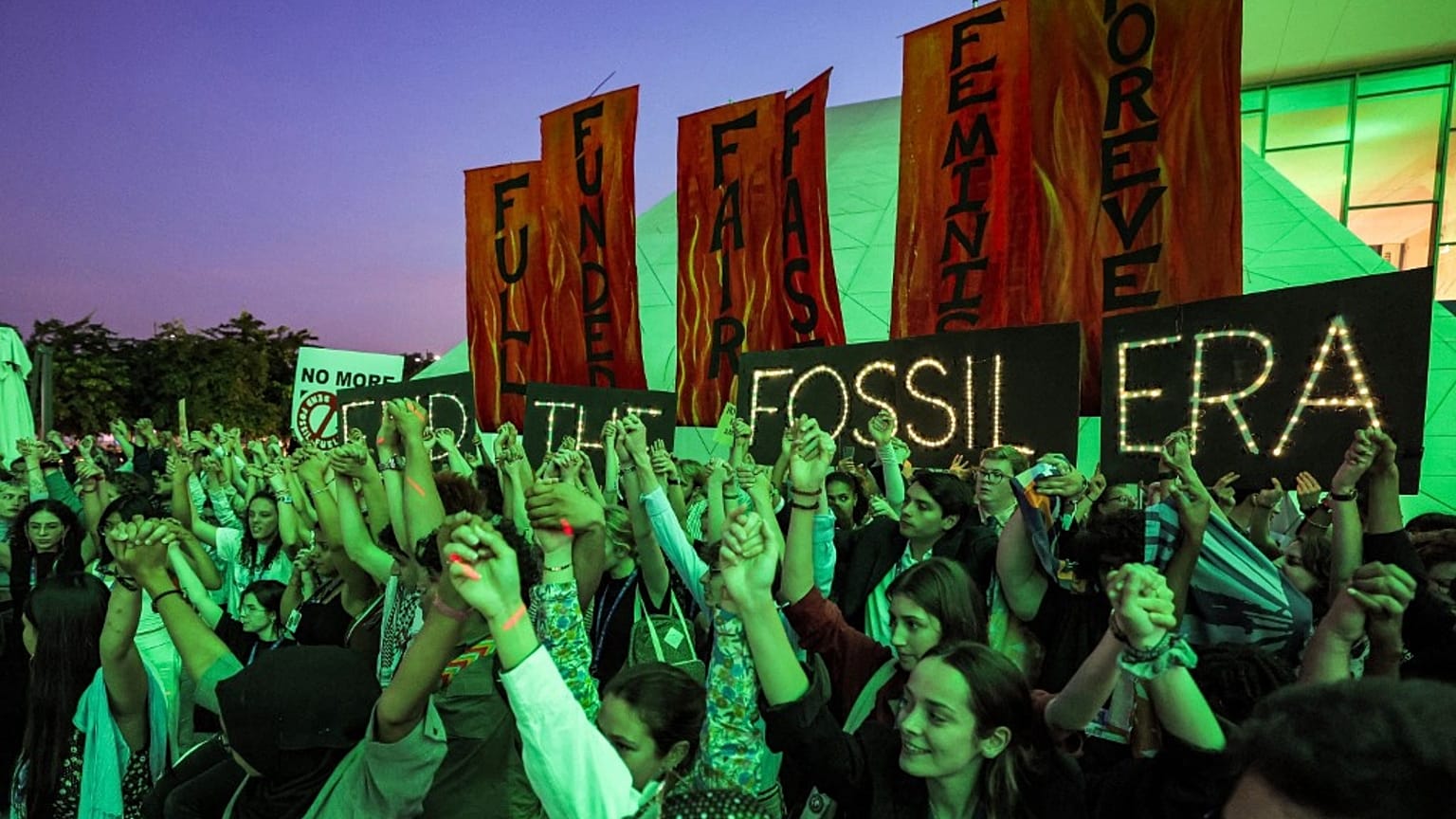 Climate activists attend a protest against fossil fuels during COP28. 