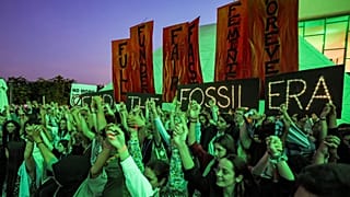 Climate activists attend a protest against fossil fuels during COP28.