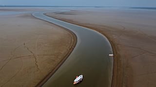 A ferry boat travels through a section of the Amazon River affected by a severe drought, near Manacapuru.