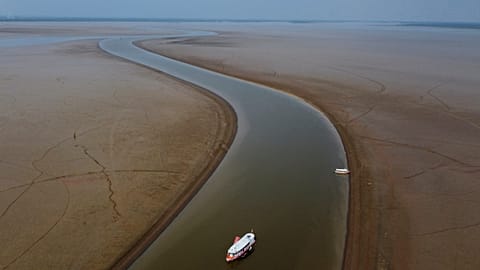 A ferry boat travels through a section of the Amazon River affected by a severe drought, near Manacapuru.