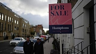 A placard shows a house for sale in London