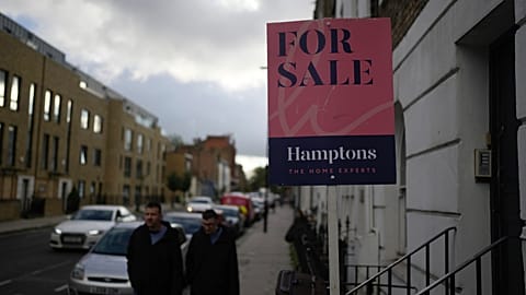 A placard shows a house for sale in London
