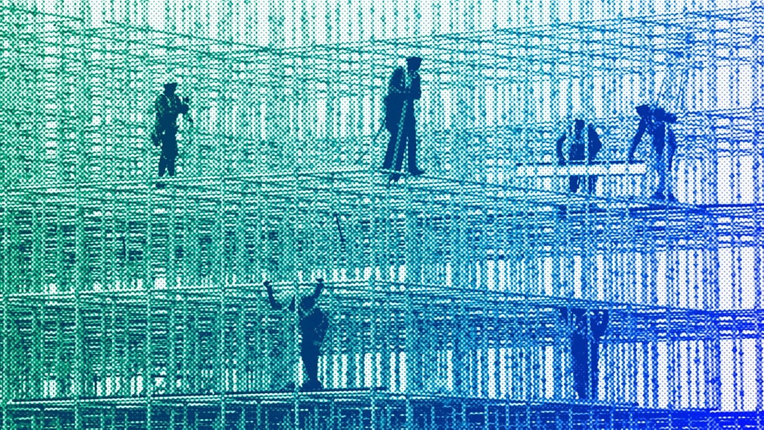 Construction workers prepare a scaffolding at a construction site in Mumbai, January 2022