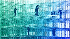 Construction workers prepare a scaffolding at a construction site in Mumbai, January 2022